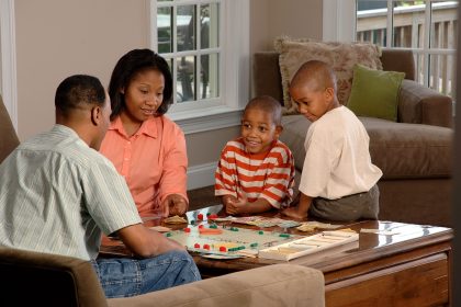 Friends playing a board game around a table